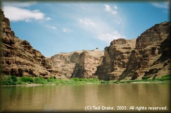 The Green River flows in stark contrast to the surrounding desert