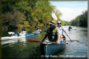 Carolee Doty takes the laid back approach as Roy Pipkin and Brian Jackson paddle by