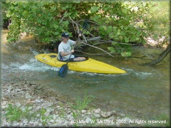 Bryant Hall kayaking a small rapid on the Nueces River